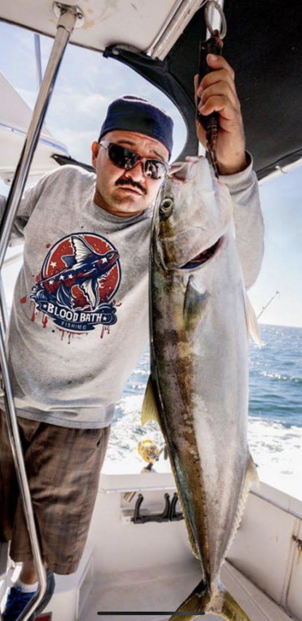 Bloodbath Fishing lifestyle — fisherman on boat holding catch